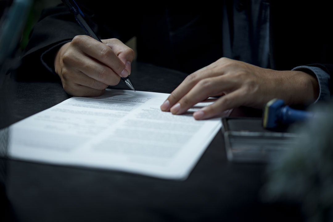 person signing a contract